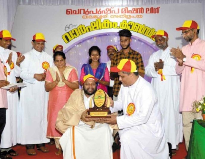 Receiving award from Bishop Mar fr. Joseph pamplani